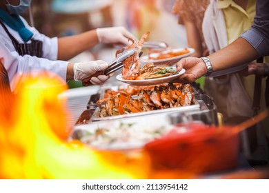Chef Cater cooking main dish crab and shrimps BBQ serving for guest in wedding ceremony party or outdoor seafood gardens. Buffet or fine dining event. Food Festival cooking catering celebrates ideas.