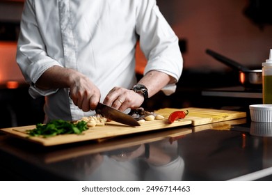 The chef is chopping ingredients in the kitchen - Powered by Shutterstock