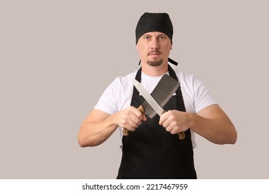 Chef cook holding kitchen knives on white background with copy space, close-up portrait - Powered by Shutterstock