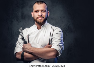 Chef cook holds a knife over dark grey background. - Powered by Shutterstock