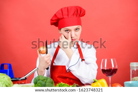 Chef cook peeling onion. Kitchen routine. Girl cooking healthy meal. Housewife cook crying while cutting onion. Slice and chop onion. Suffer but keep doing. Stinging eyes and tears cutting onions.