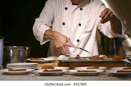 A chef or cook is preparing multiple dishes. - Powered by Shutterstock