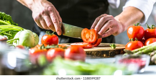 Chef cook preparing vegetables in his kitchen. - Shutterstock ID 1188599287