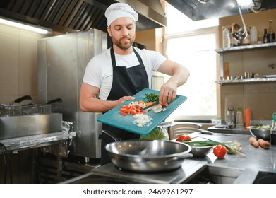 Chef cook preparing vegetables in his kitchen. - Powered by Shutterstock