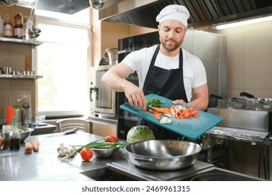 Chef cook preparing vegetables in his kitchen. - Powered by Shutterstock