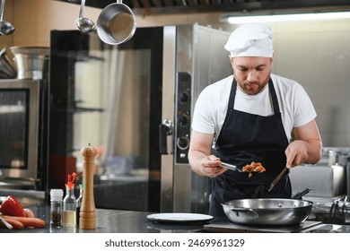 Chef cook in uniform cooking in the big cooker at the restaurant kitchen. - Powered by Shutterstock