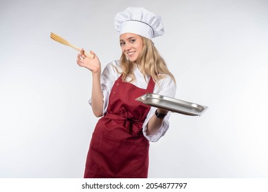 Chef Cook Woman. Chef With Empty Tray In Hand. Girl Cook Demonstrates Something. She Holds Out Empty Tray To Camer Place To Showcase Dish. Concept - Restaurant Chef Recommends. Cook Studio Portrait