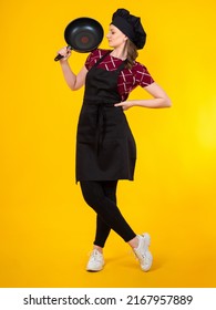 Chef Cook Woman. Cook Woman With Frying Pan. Cook Full Length Portrait. Girl In Chef Uniform. Confident Woman Restaurant Worker. Catering Employee Career. Chef Girl On Yellow Background