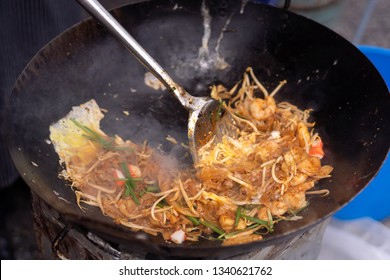 Chef Cooking The Chinese Char Koay Teow, Or Fried Flat Rice Noodle. Penang Famous Hawker Food.