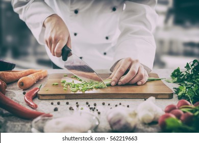 chef cooking food kitchen restaurant cutting cook hands hotel man male knife preparation fresh preparing concept - stock image - Shutterstock ID 562219663