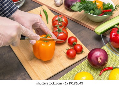 Chef Cooking Healthy Vegetarian Vegan Diet Food. Hands In Latex Gloves Cutting Orange Pepper And Various Vegetables