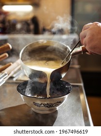 Chef Cooking Japanese Ramen Noodle Soup With Adding Broth