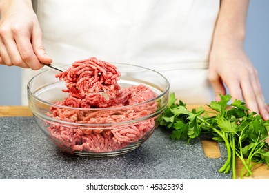 Chef cooking in kitchen with ground beef
