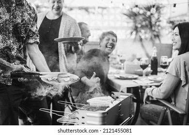 Chef Cooking Meat At Barbecue Family Dinner Outdoor In The Backyard - Focus On Left Hand - Black And White Edition