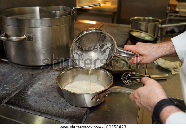 Chef Cooking Sauce On Electric Stove Stock Photo Edit Now 100358423