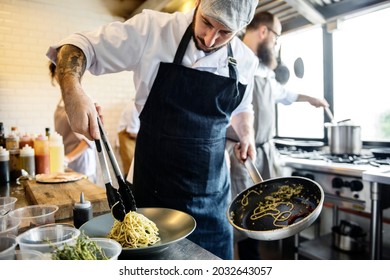 Chef Cooking Spagetti In The Kitchen