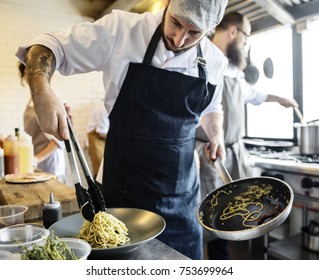 Chef Cooking Spagetti In The Kitchen