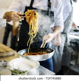 Chef cooking spaghetti in the kitchen