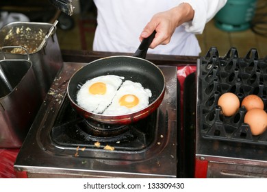 A Chef Is Cooking Sunny-side Up Eggs