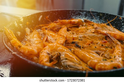 Chef Cooking With Tiger Prawn On Background Sun Light Efect
