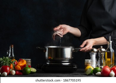 Chef cooking traditional asian dish and testing it with spoon. Backstage of preparing seafood on dark blue background. Concept of exotic asian cuisine. Frozen motion. - Shutterstock ID 1867705195