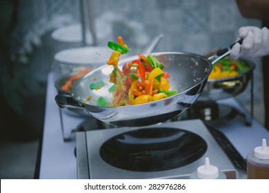 Chef Cooking Vegetables In Wok Pan. Shallow Dof