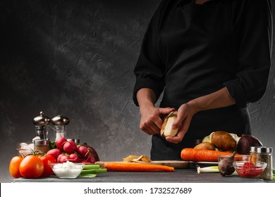 The chef cooks a dish of potatoes and vegetables. Peels potatoes. Diet, veggie, proper and tasty food. Sale of vegetables, market, organic vegetables. With space for design. - Powered by Shutterstock