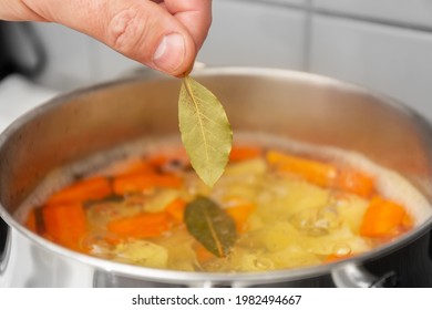 The Chef Cooks Finnish Salmon Soup. The Cook Puts A Bay Leaf In A Saucepan. 