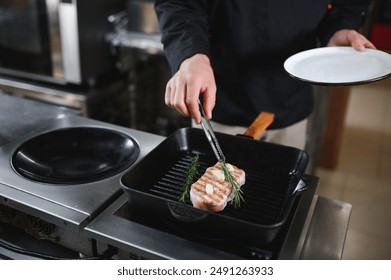 Chef cooks pork steak. Recipe book, cooking, restaurant business. - Powered by Shutterstock