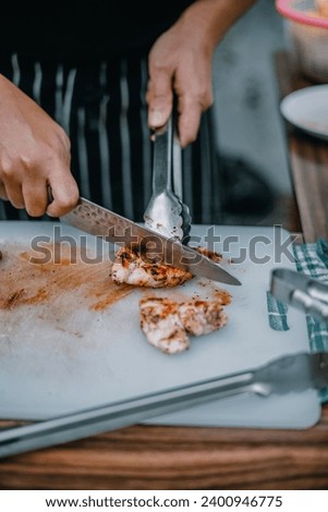 Chef cut a meat with knive