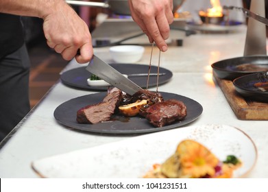 Chef, Cuts Pieces Of Meat Cooked On Fire To Put It Nicely On A Plate, Cooking Show