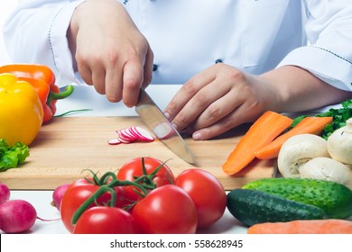 Chef cuts radishes in a vegetable salad - Powered by Shutterstock