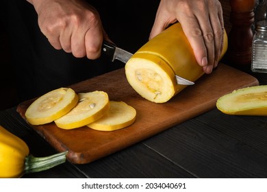 The Chef Cuts Ripe Yellow Marrow With A Knife. Fried Zucchini Is A Great Diet For Breakfast Or Lunch. Work Environment On The Kitchen Table Of The Restaurant.