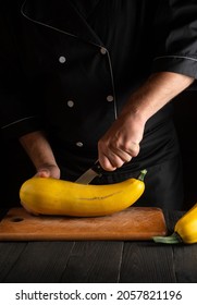 The Chef Cuts Ripe Yellow Marrow With A Knife. Fried Zucchini Is Great Diet For Breakfast Or Lunch. Work Environment On The Kitchen Table Of The Restaurant