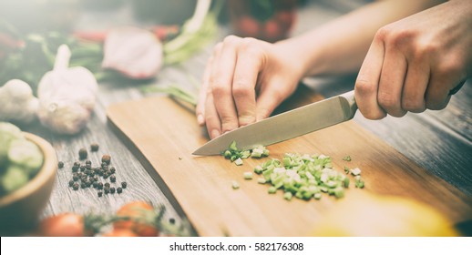 Chef cuts the vegetables into a meal. Preparing dishes. A woman uses a knife and cooks. - Powered by Shutterstock