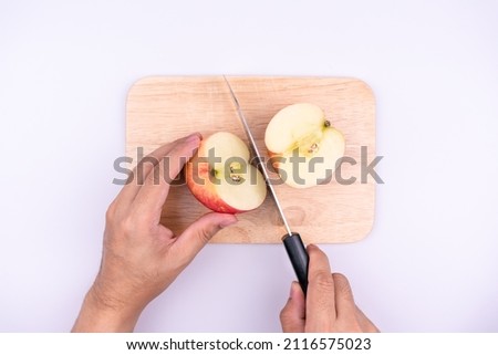 chef cutting apple before cooking concept on a cutting board isolated on a white background, Sweet and juicy fruit, top view