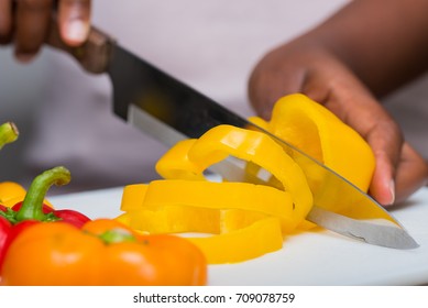 chef cutting bell peppers on cutting board - Powered by Shutterstock