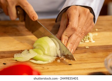 chef cutting fresh onion on wooden board preparing seasoning - Powered by Shutterstock