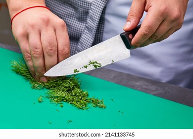 Chef Cutting Onion On The Kitchen