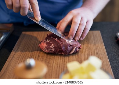 Chef Cutting A Raw Beef Cheek 