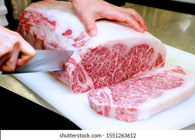 Chef cutting raw Japanese  wagyu beef