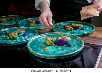 Chef Decorates The Salmon Cooked Using Sous Vide Technology With Liquid French Fries And Spheres From Tartar Sauce. Master Class In The Kitchen. The Process Of Cooking. Step By Step. Close-up.