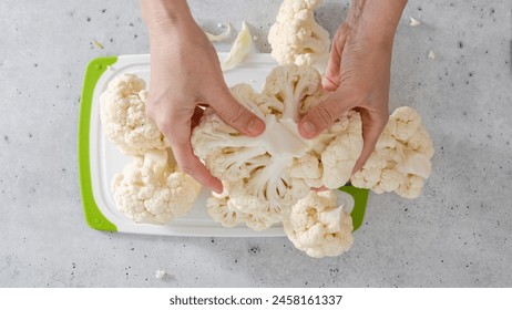 The chef devided cauliflower into florets, the cooking process, view from above. Oven-roasted cauliflower recipe. - Powered by Shutterstock