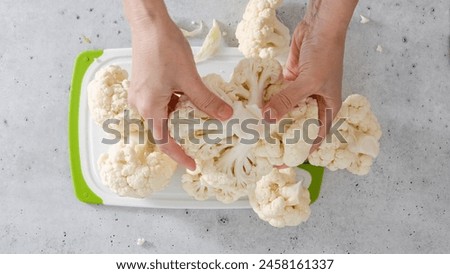 The chef devided cauliflower into florets, the cooking process, view from above. Oven-roasted cauliflower recipe.