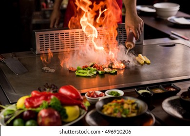 Chef doing flambe while preparing teppanyaki