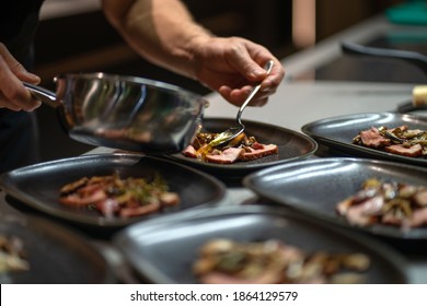 Chef fills up the plate for a beautiful presentation of delicious cooked food - Powered by Shutterstock