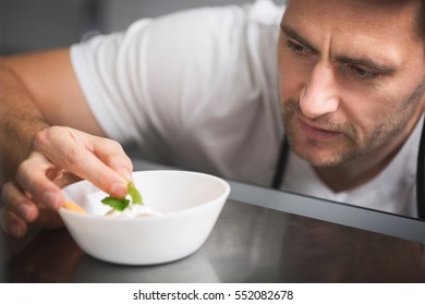 Chef focused on preparing dish