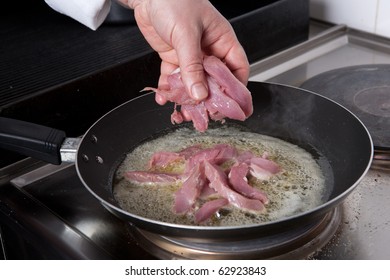 Chef Frying Meat In A Pan