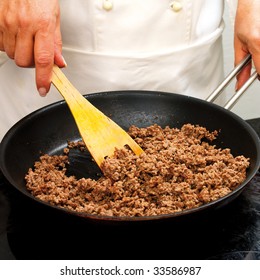 Chef Frying Minced Meat In A Pan