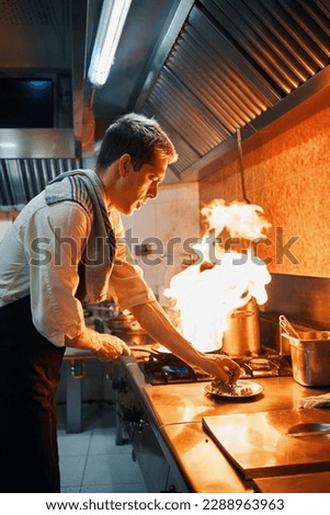 chef with frying pan on fire